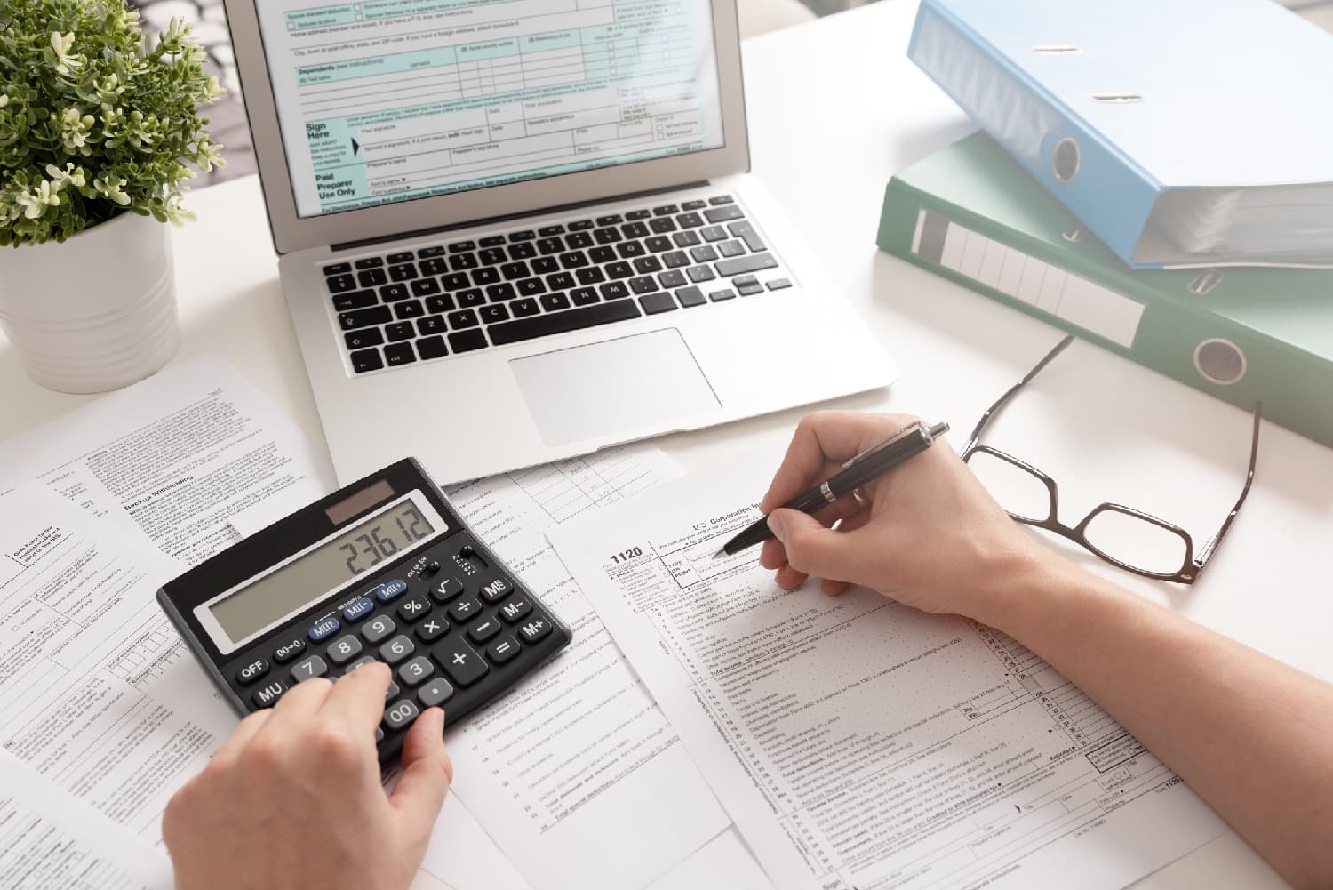 Accountant working with a laptop and a calculator